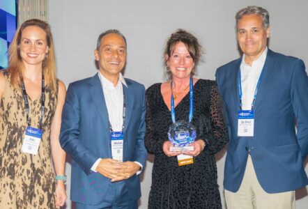 Shelley Garlington, Growth Director of HBSUK, receiving an award from colleagues from Intersystems