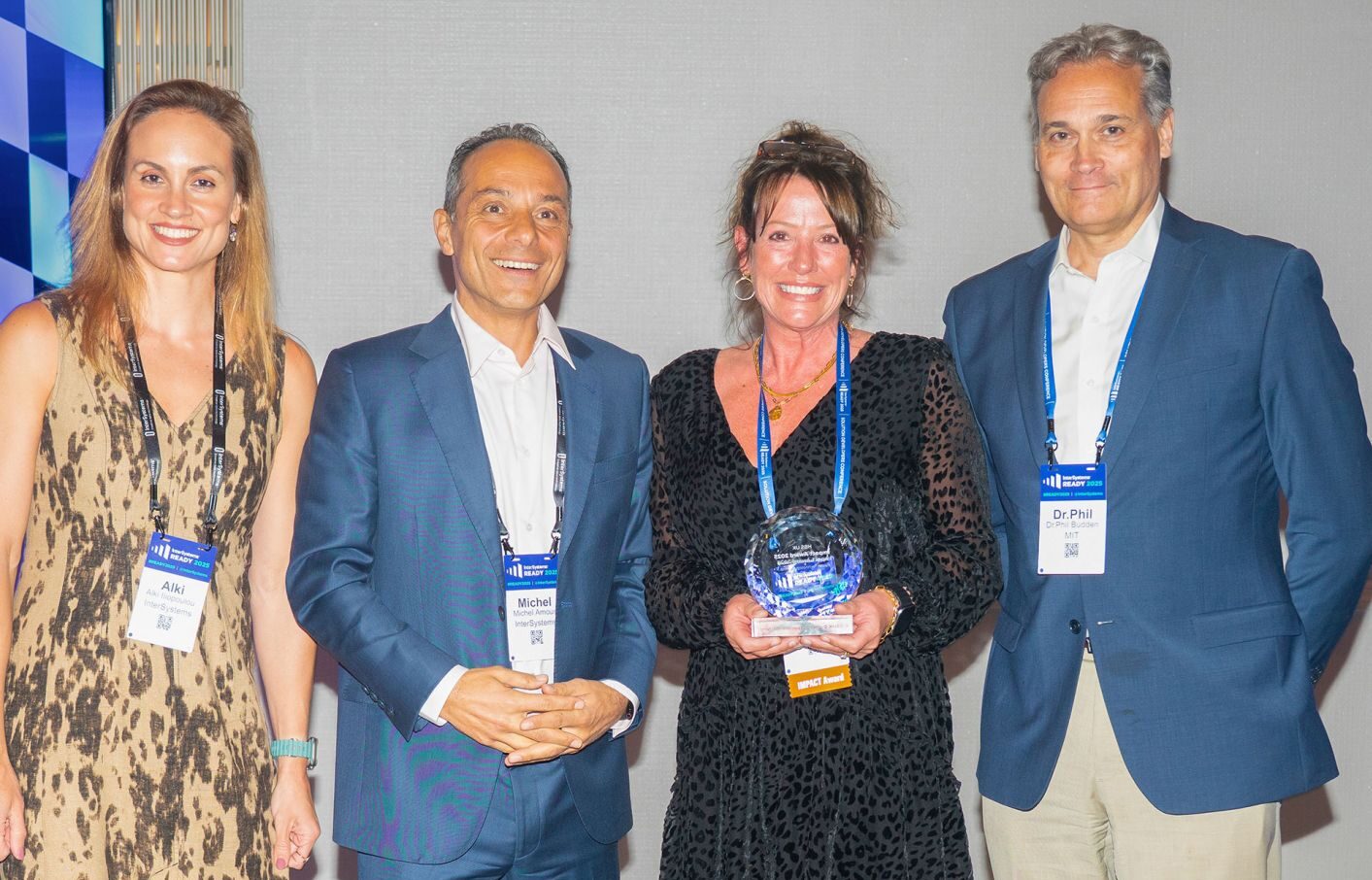 Shelley Garlington, Growth Director of HBSUK, receiving an award from colleagues from Intersystems