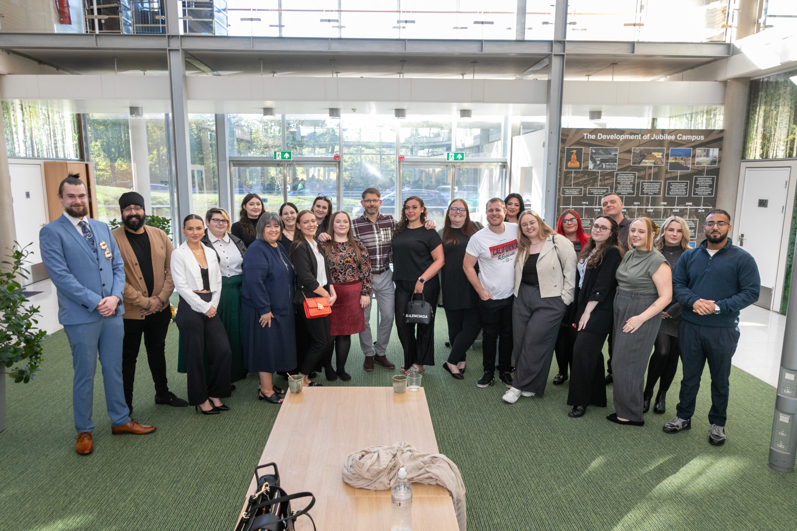 A group photograph of staff members of HBSUK smiling at the camera