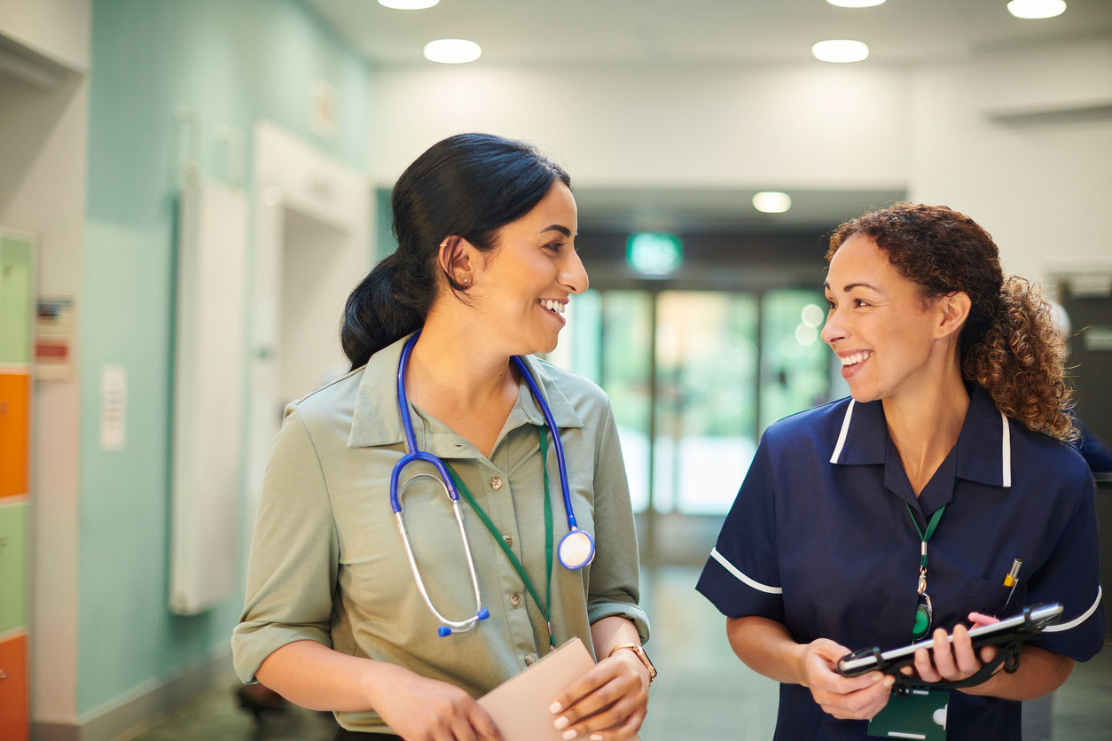 A senior nurse chatting to hospital doctor