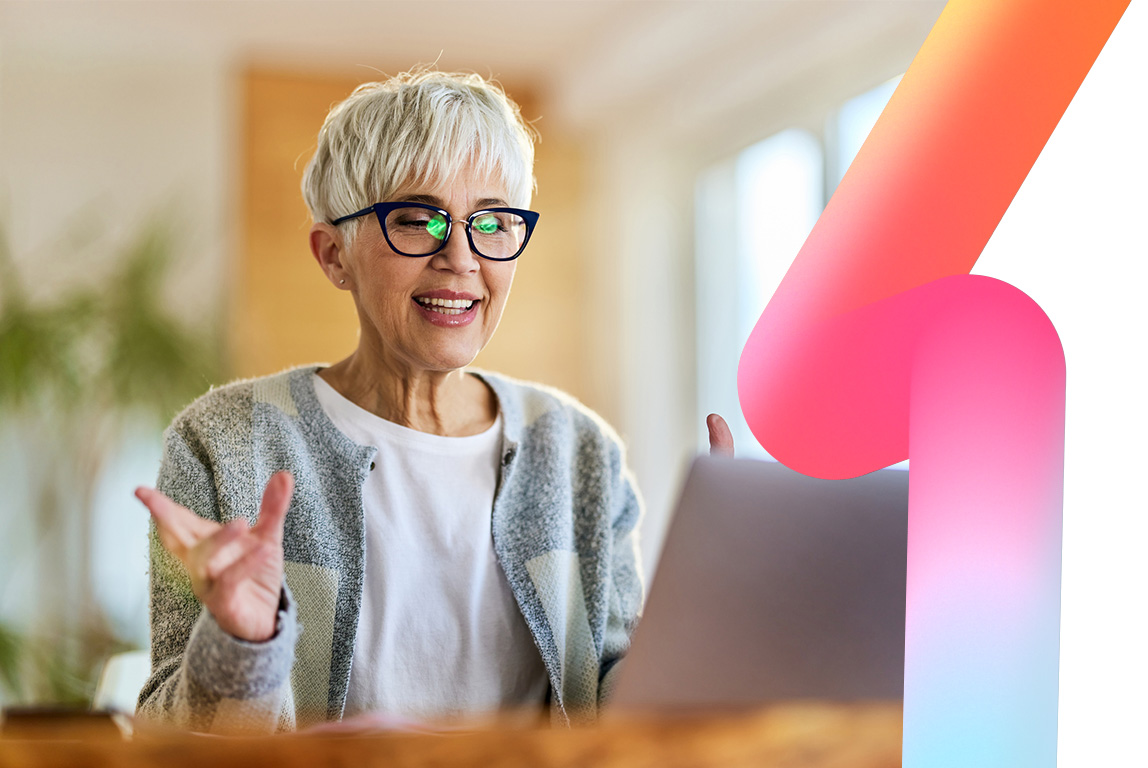 Happy woman having a video call over a computer at home.