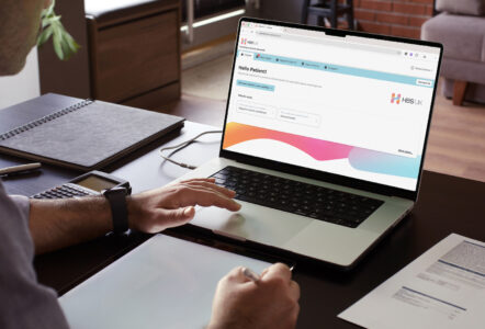 A photograph of the HBS Platform interface on a laptop computer