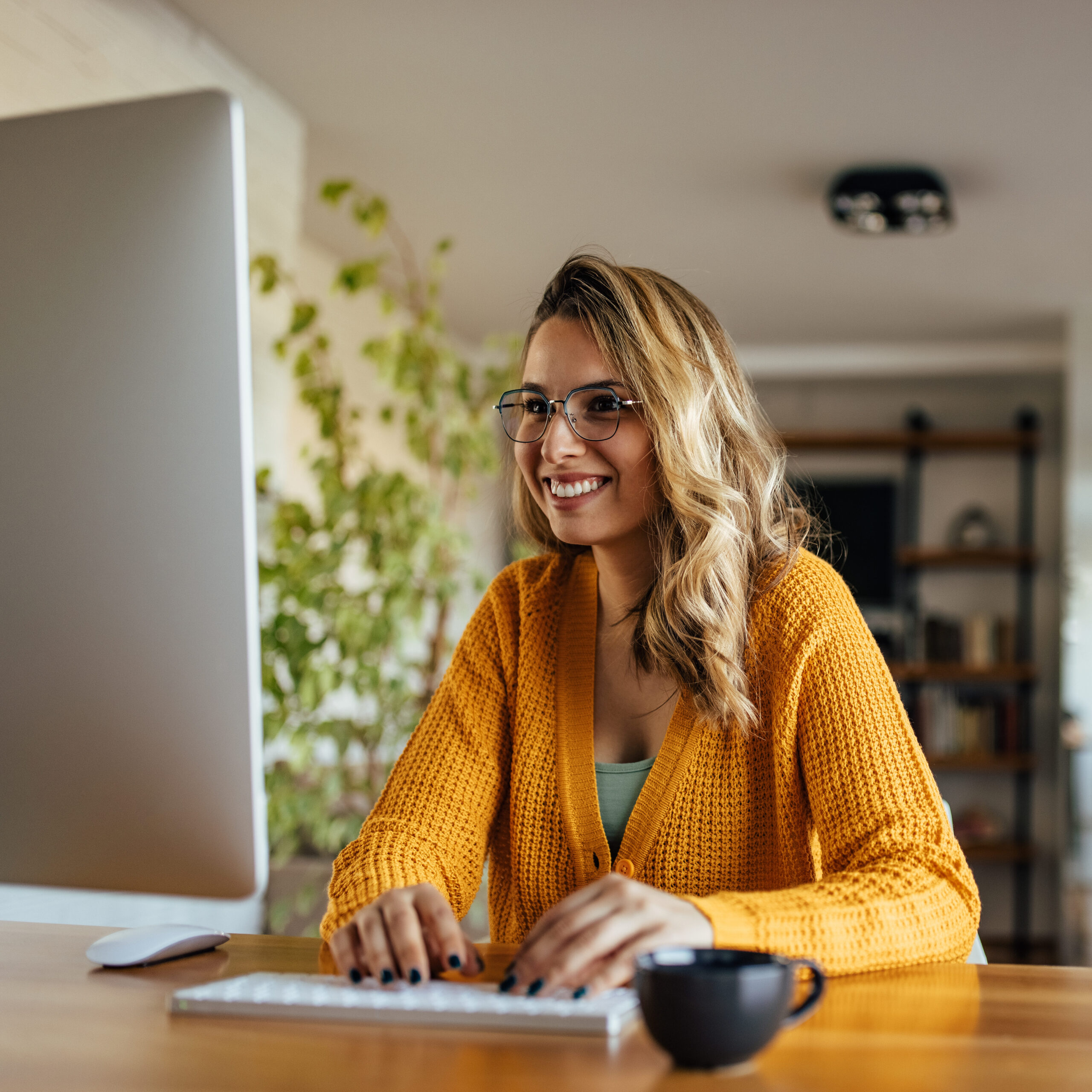 A woman sitting at a desk using her computer for work