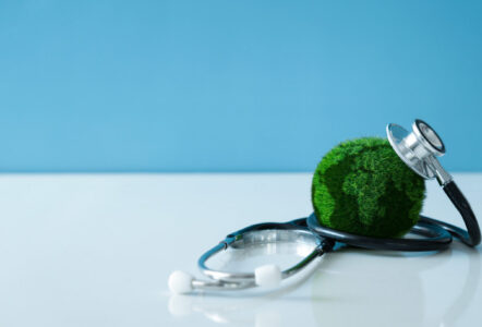 An image of a small earth with a stethoscope on it, symbolising the health of the planet