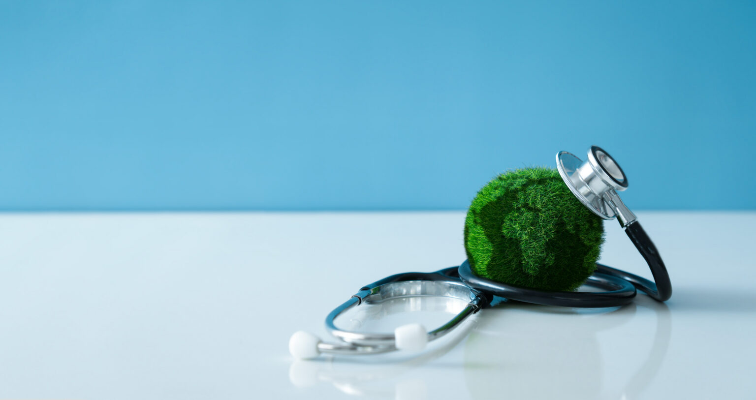 An image of a small earth with a stethoscope on it, symbolising the health of the planet